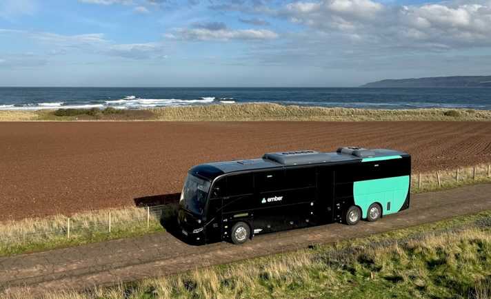 Ember bus with cyclists passing